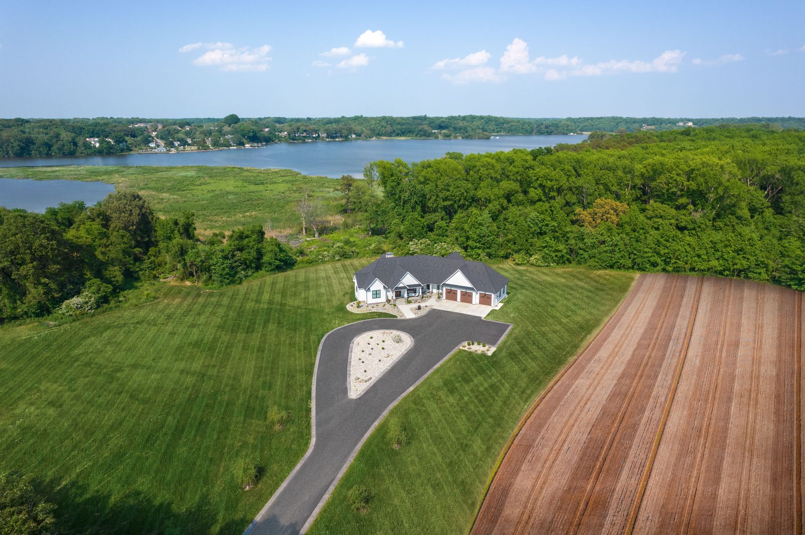 Aerial view of the Bayview Farmhouse custom waterfront home by Shady Lane Construction, Breton Bay MD